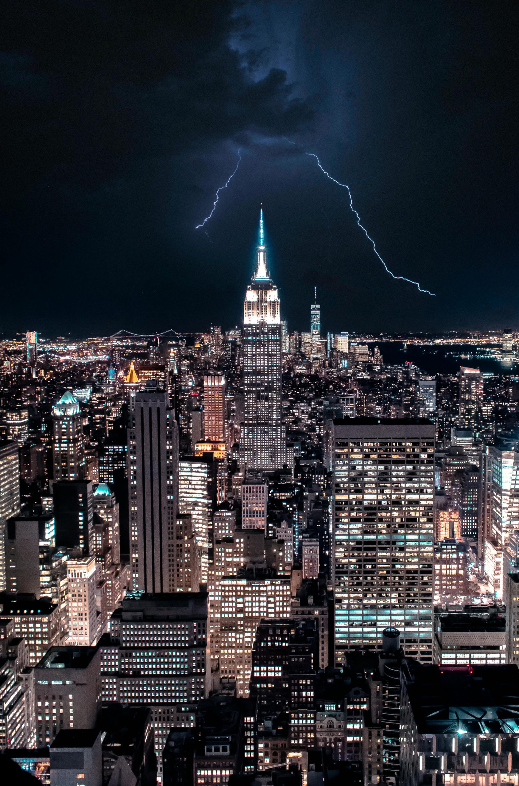 Dramatic view of NY skyline with lightning striking the Empire State Building.
